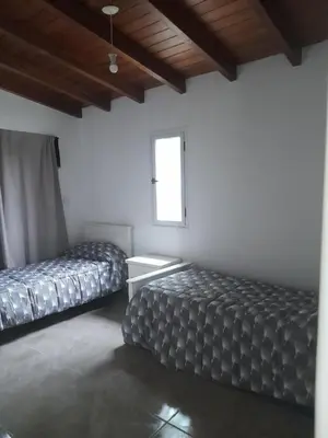 a room with two beds and a window at Casa los nonos in Cordoba