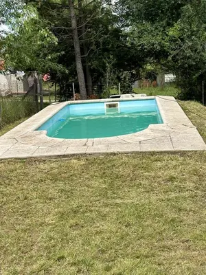 a small swimming pool in a grassy yard at Alma ina in Villa Yacanto