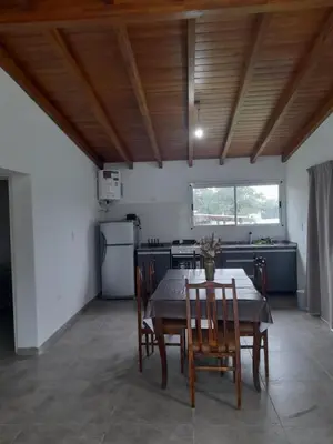 a kitchen with a table and chairs in a room at Casa los nonos in Cavalango