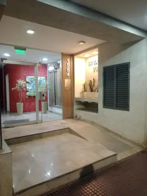 a lobby of a building with a sign on the wall at Departamento en Gral paz in Cordoba