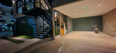 a building with a motorcycle parked inside of it at Vivisierras, Duplex a estrenar con pileta privada centro Villa Carlos Paz, 3 dormitorios, 2 baños, vista in Villa Carlos Paz
