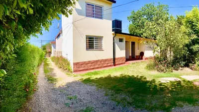 a house with a pathway leading up to it at Aires de las Sierras in Villa Carlos Paz