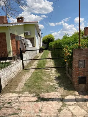 a fence in front of a house at Aires de las Sierras in Villa Carlos Paz