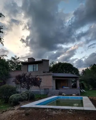 a house with a swimming pool in front of it at Hermosa casa en Potrero de Garay in Potrero de Garay