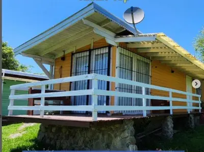 a house with a balcony on top of it at CABAÑAS LA GUADALUPE in Villa Yacanto