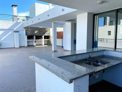 a kitchen counter with a sink in front of a building at Edificio Tempo in Villa Carlos Paz