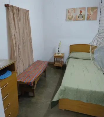 a bedroom with a bed and a bench in it at La casona Segunda Usina in Embalse