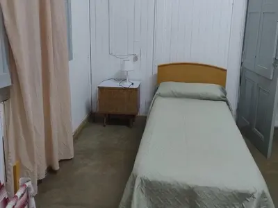 a bedroom with two beds and a lamp on a table at La casona Segunda Usina in Embalse