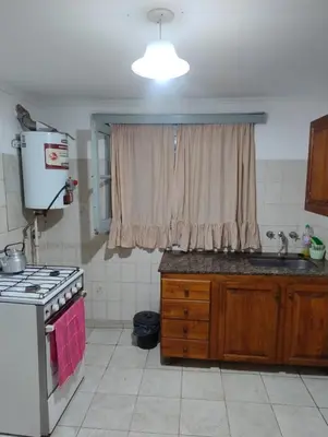 a kitchen with a stove and a sink and a window at La casona Segunda Usina in Embalse
