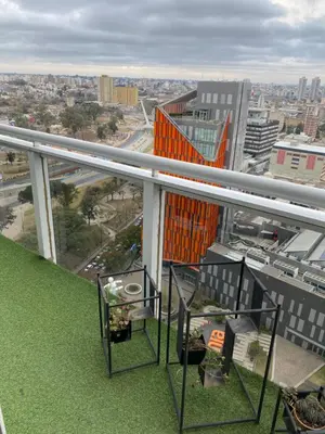 a balcony of a building with a view of a city at DEPARTAMENTO SUITE DE LUXE EN EL CENTRO in Cordoba