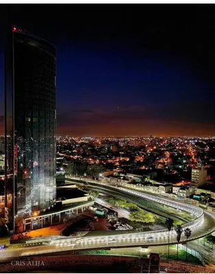 a city skyline at night with a tall building at DEPARTAMENTO SUITE DE LUXE EN EL CENTRO in Cordoba