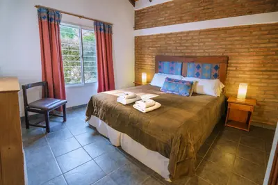 a bedroom with a large bed with towels on it at El Portillo in Villa General Belgrano