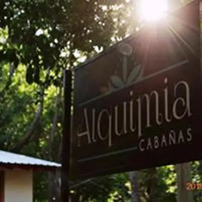 a sign for a restaurant with the sun shining on it at Alquimia Cabañas in San Francisco del Monte de Oro