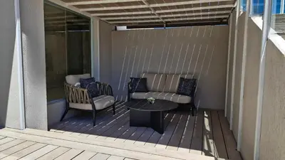 a patio with a couch and a table on a deck at Amérian Executive Córdoba in Cordoba