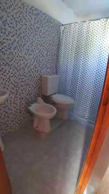 a bathroom with two toilets and a sink at Tierra Santa in Villa Cura Brochero