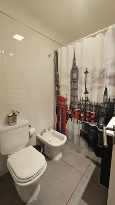 a bathroom with a toilet and a sink and big ben at LitStay Laprida 2 in Cordoba