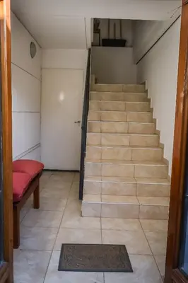 a stairway with a red bench and a stair case at Dpto con Balcón- Rafael Nuñez - Cerro de las Rosas in Cordoba