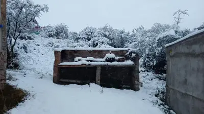 a bench covered in snow in a yard at Cabañas La Rustica 6p in Bialet Massé