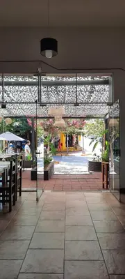 a patio with a table and chairs in a building at HOTEL OLIVIA in Mina Clavero