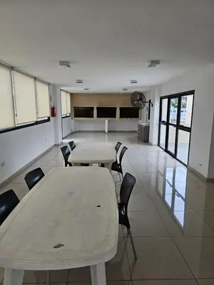 a room with two tables and chairs in a building at Apartamento Esquiu C in Villa Carlos Paz