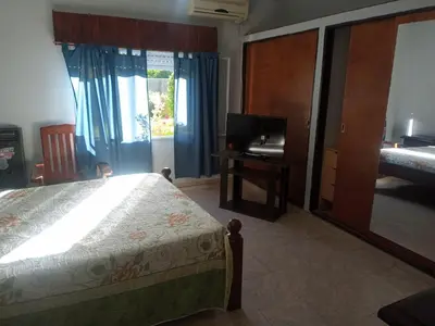 a bedroom with a bed and a desk and a television at Casa en Las Tapias cerca de Villa de Las Rosas in San Javier