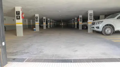 a parking lot with cars parked in a parking garage at Apart France - Con gim, piscina y estacionamiento in Río Cuarto