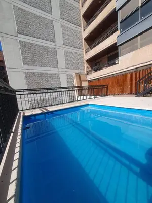 a large swimming pool in front of a building at LOAN Nueva Cordoba 9E in Cordoba