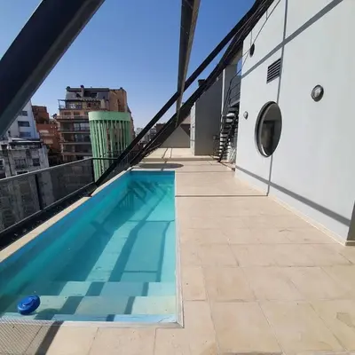 a swimming pool on the roof of a building at LOCADOR Nueva Cordoba 3C in Cordoba