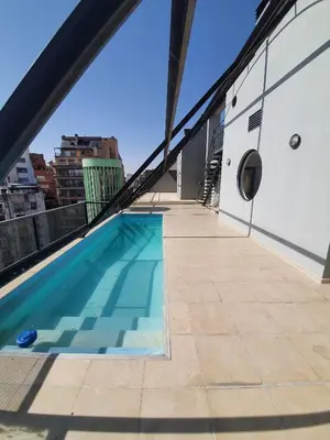 a swimming pool on the roof of a building at Nueva Cordoba 3D in Cordoba