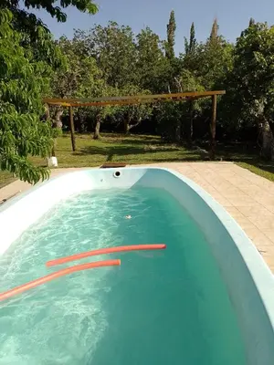 a swimming pool with a red line in the water at Cabañas Nicasio in Merlo