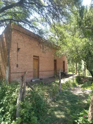 an old brick building with a fence in front of it at Casa alma verde alegría y paz in Luyaba