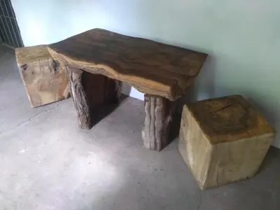a wooden table with a stool and a table made out of logs at Casa Alma Verde armonia in Luyaba