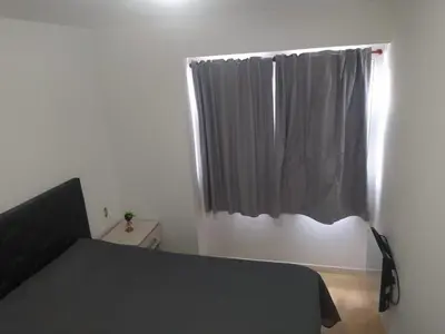 a bedroom with a black bed and a window at Costanera 3 dormitorios 2 cocheras estamos a 800 metros del centro in Cordoba