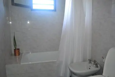 a bathroom with a tub and a toilet and a sink at Loft terraza del norte a mts de sanatorio Allende, Hospital Privado y estadio Kempes in Cordoba