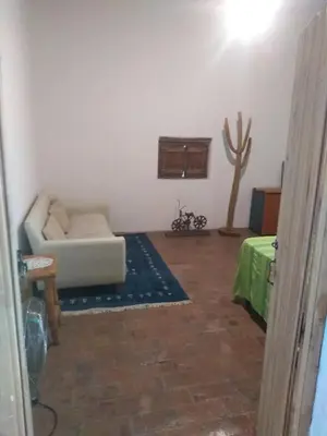 a living room with a couch and a table at Casa alma verde in Luyaba