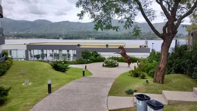 a statue of a giraffe standing next to a building at Veneto Village, Complejo Vacacional in Villa Parque Siquiman